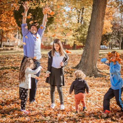 Family throwing leaves in park 2