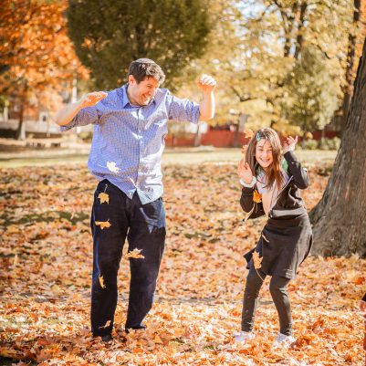 Family throwing leaves in park 3