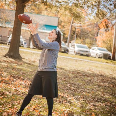 Woman playing football in park 1
