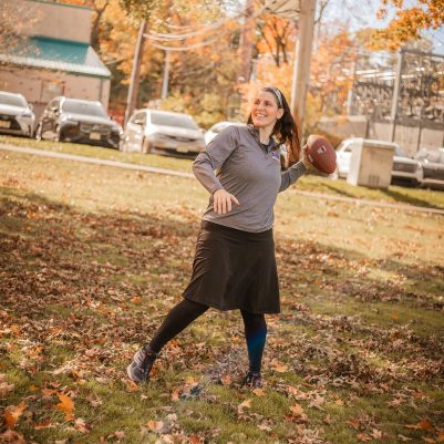 Woman playing football in park 2