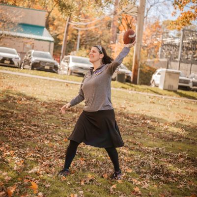 Woman playing football in park 3
