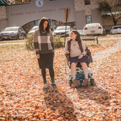 Woman in wheelchair at park with friend 2