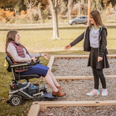 Woman in wheelchair and girl at park 2