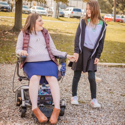 Woman in wheelchair and girl at park 4