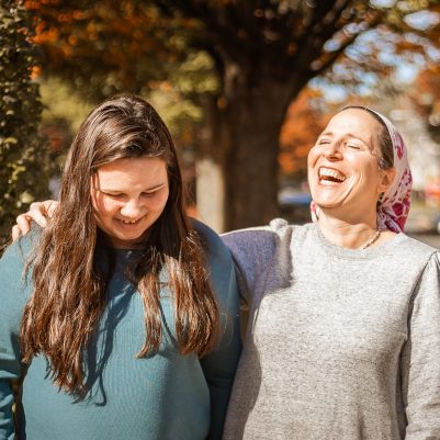Mother and daughter laughing on a walk
