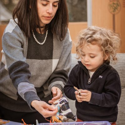 Mother helping son play game
