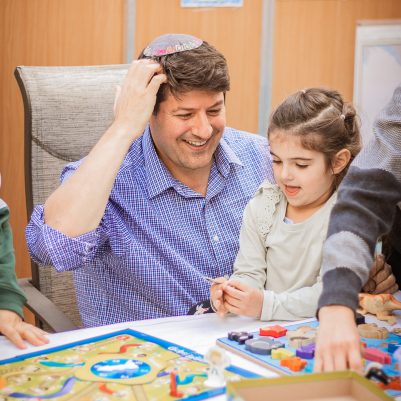 Father and daughter playing board game