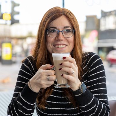 Smiling woman drinking coffee at restaurant 1