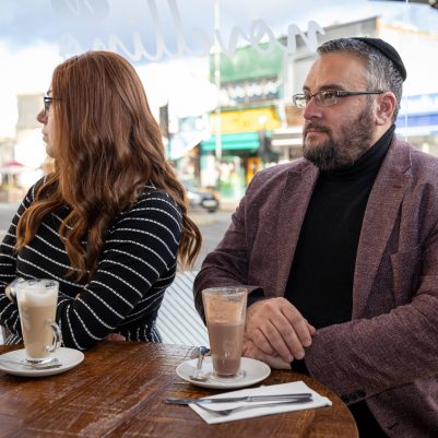 Couple sitting at restaurant next to window