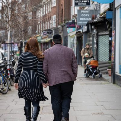 Couple walking on busy street 1
