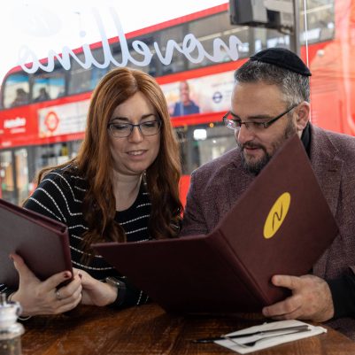 Couple looking at menu in London restaurant