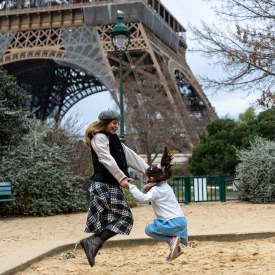 Mother and daughter jumping in front of the Eiffel Tower