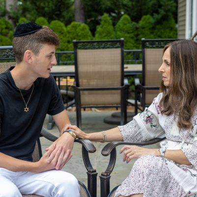 Mother and son in discussion on patio