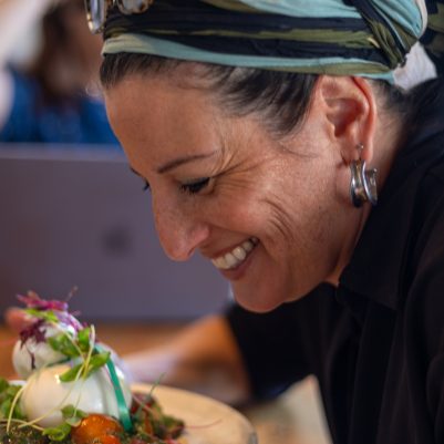 Woman looking at salad in restaurant
