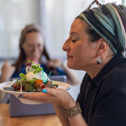 Woman smelling salad at restaurant