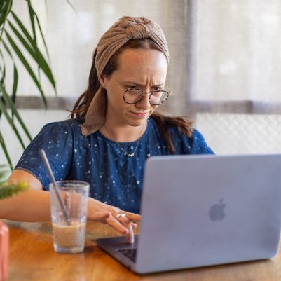 Woman looking at computer concerned 1
