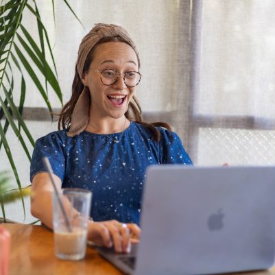 Woman looking at computer surprised