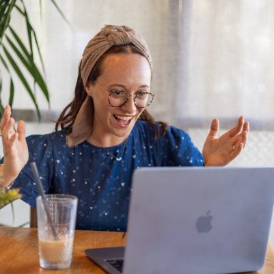 Excited woman looking at computer