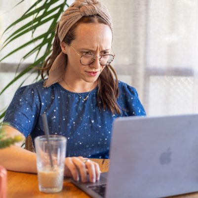 Woman looking at computer concerned 2
