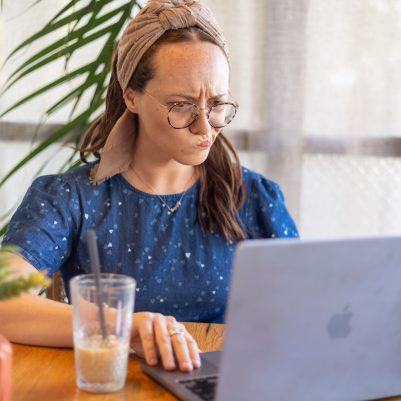 Woman looking at computer confused