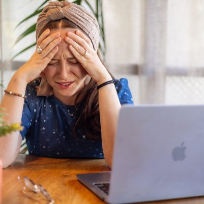 Woman crying next to computer 1