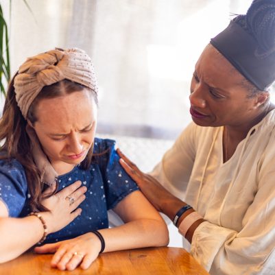 Woman comforting upset woman 2