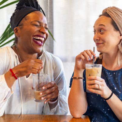 Two women laughing in cafe 1
