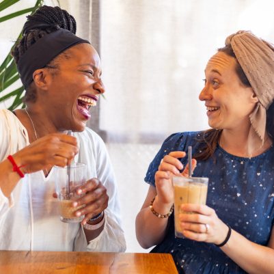 Two women laughing in cafe 2