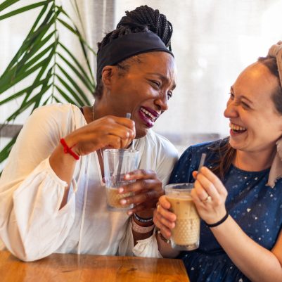 Two women laughing in cafe 3