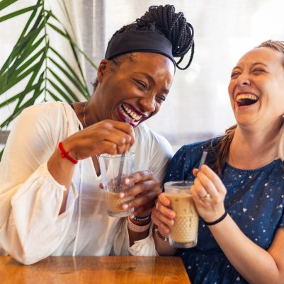 Two women laughing in cafe 4