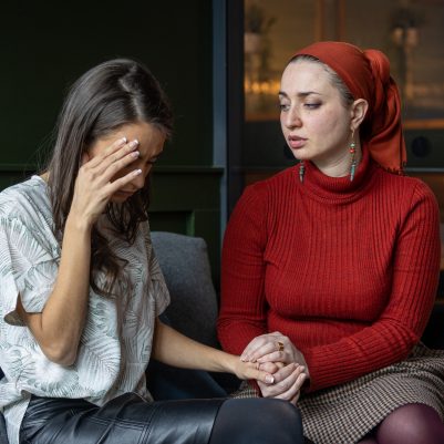 Woman comforting crying friend