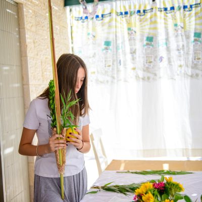 Teenager shaking lulav and etrog 1