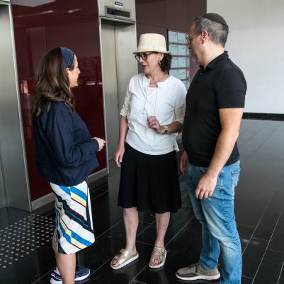 Couple chatting with woman in lobby 1