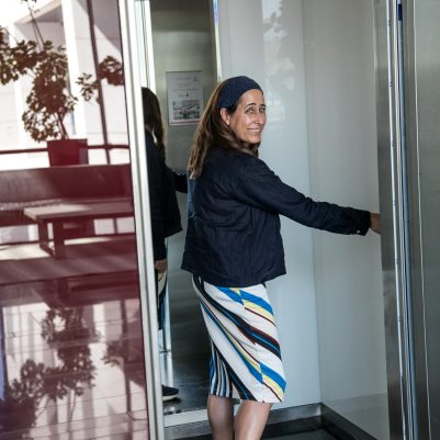 Woman pressing button in elevator 2