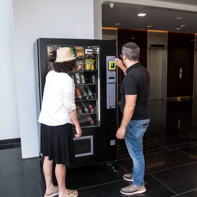 Couple standing in front of vending machine