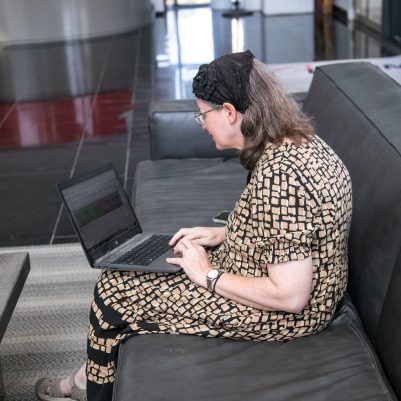Woman sitting on couch working on laptop 4