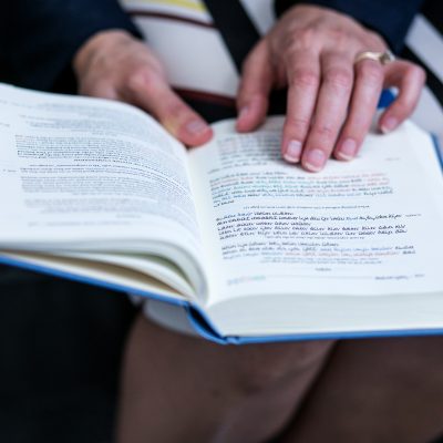 Woman praying from siddur 1