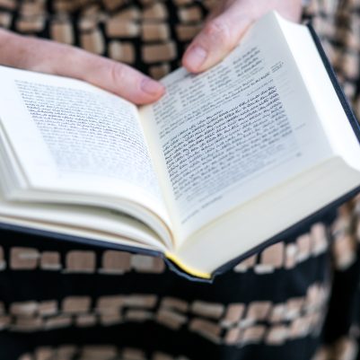 Woman praying from siddur 3