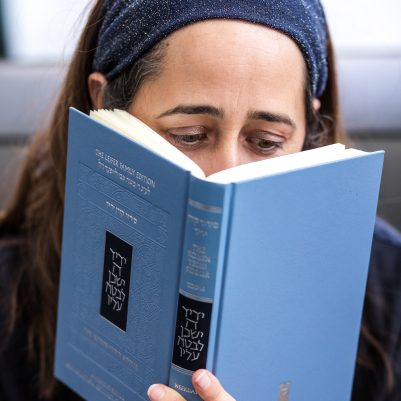 Woman praying from siddur 4