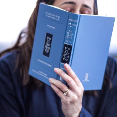 Woman praying from siddur 5