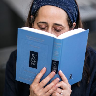 Woman praying from siddur 6