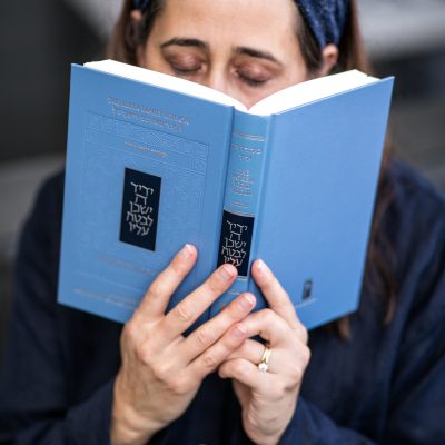 Woman praying from siddur 7