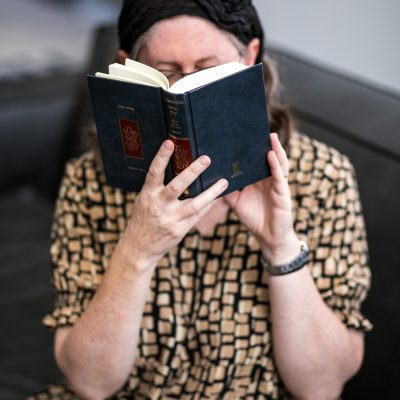 Woman praying from siddur 8