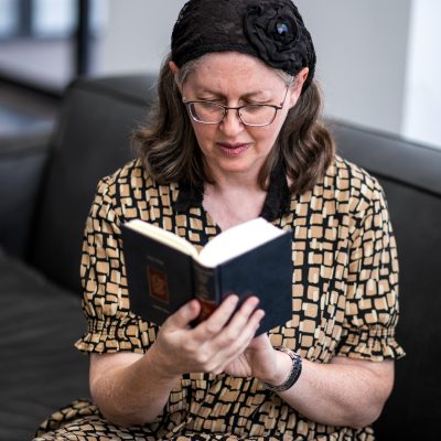 Woman praying from siddur 9