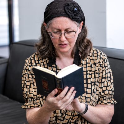 Woman praying from siddur 10