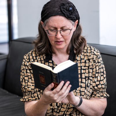 Woman praying from siddur 10