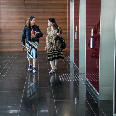 Two women walking in lobby