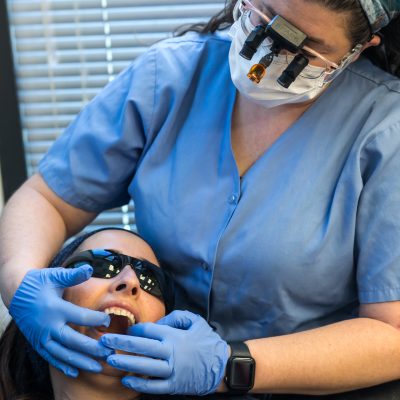 Dentist examining woman's teeth 1