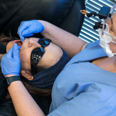 Dentist examining woman's teeth 3