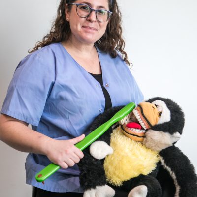Dentist demonstrating toothbrush on stuffed animal 3